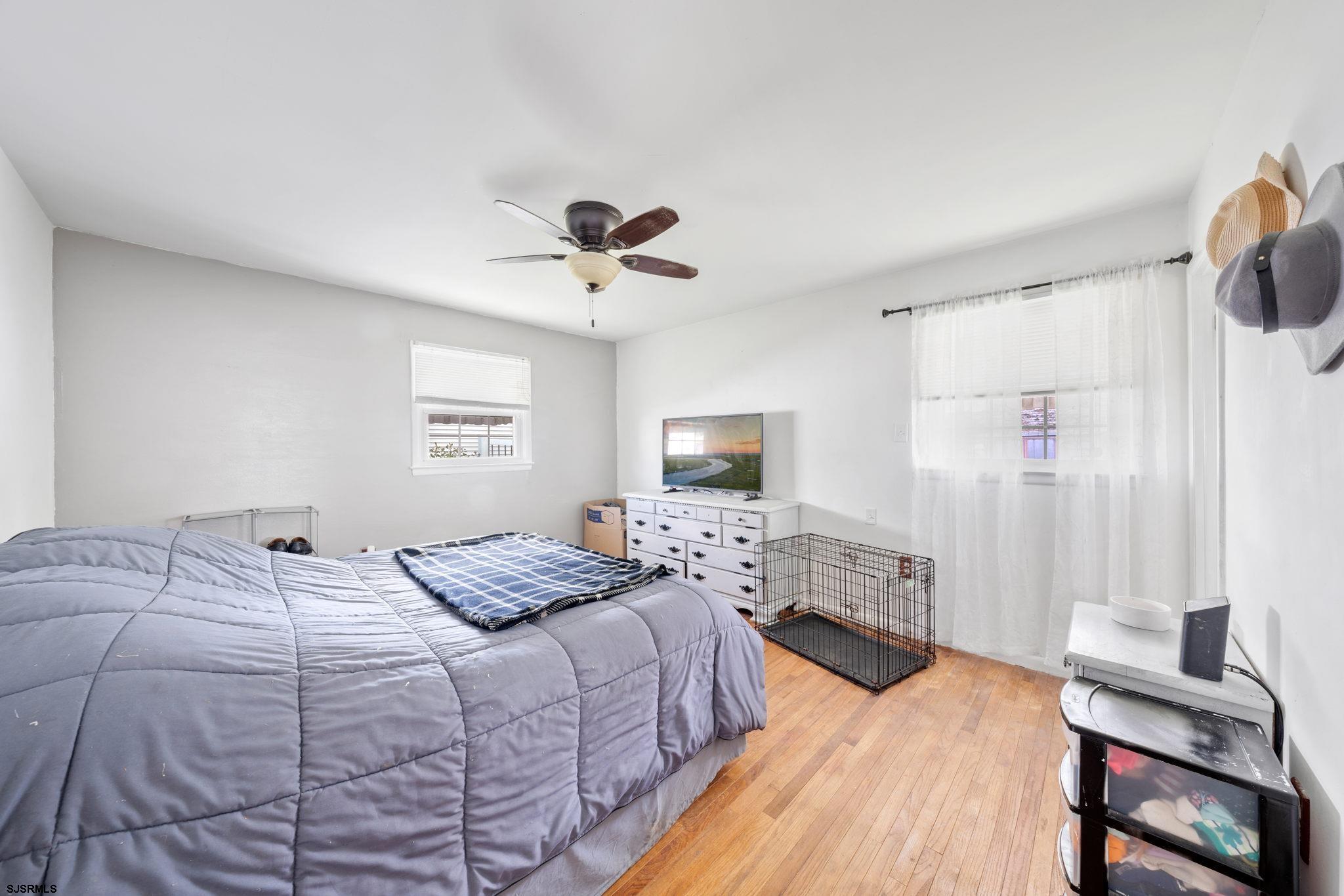 40 Gulph Mill Road Somers Point, NJ 08244 - Photo 10 of 21 a bedroom with a bed and a chandelier