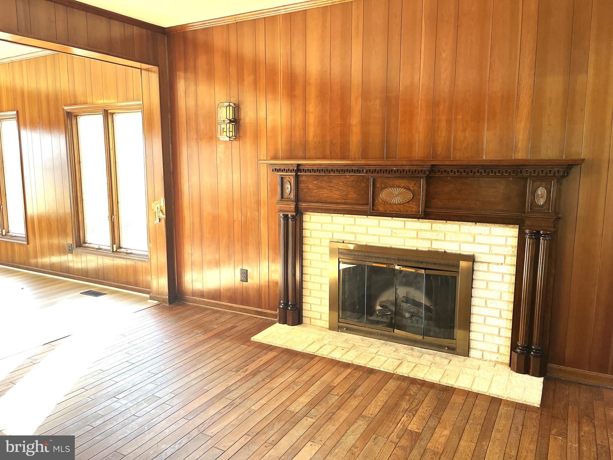 3901 Belle Rive Terrace Alexandria, VA 22309 - Photo 28 of 31 a view of an empty room with wooden floor and a fireplace