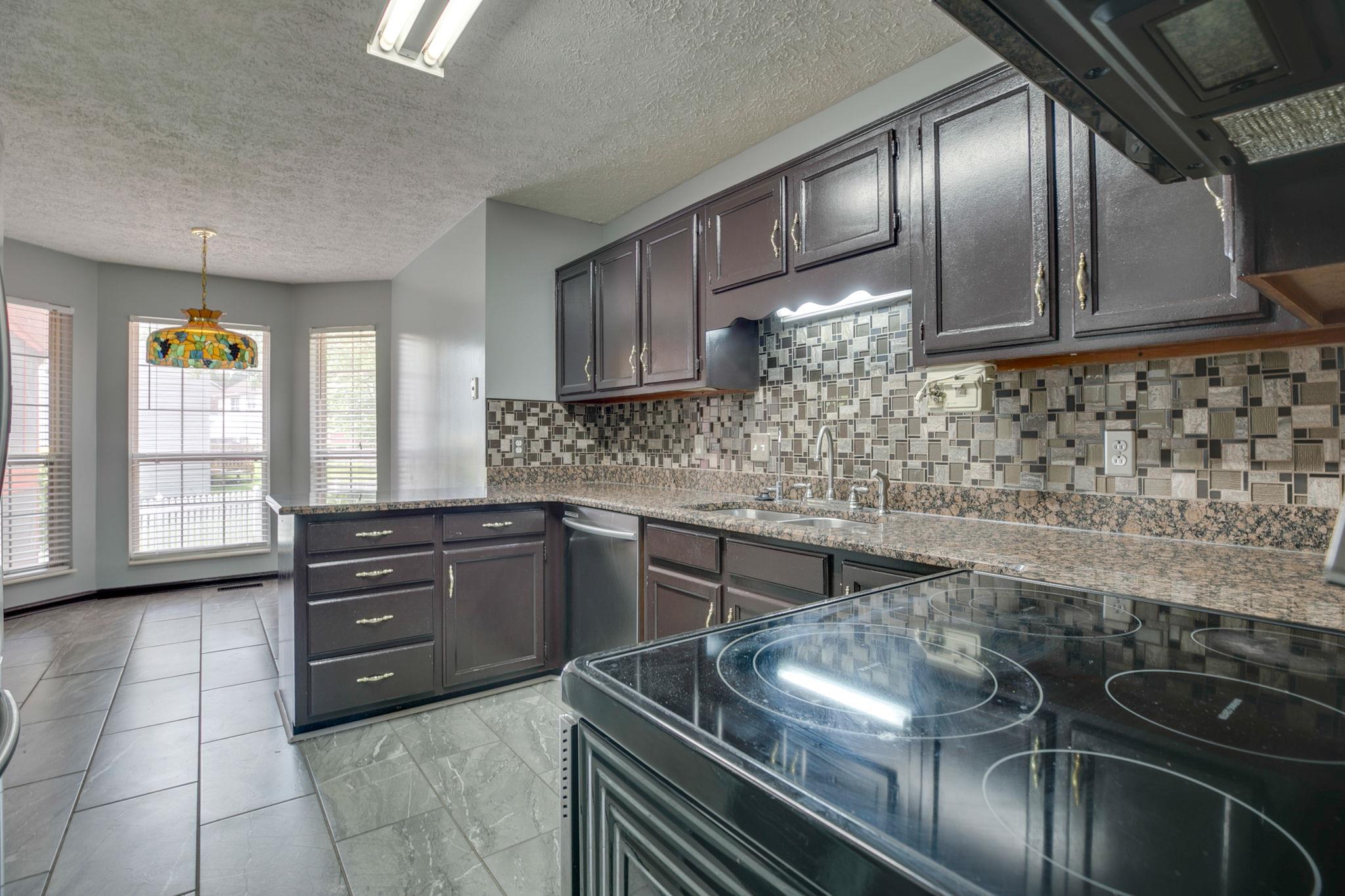 3429 Shakertown Road Antioch, TN 37013 - Photo 8 of 27 Lovely Kitchen- Great Cabinet Space, Granite Counters & Custom Tiled Backsplash!