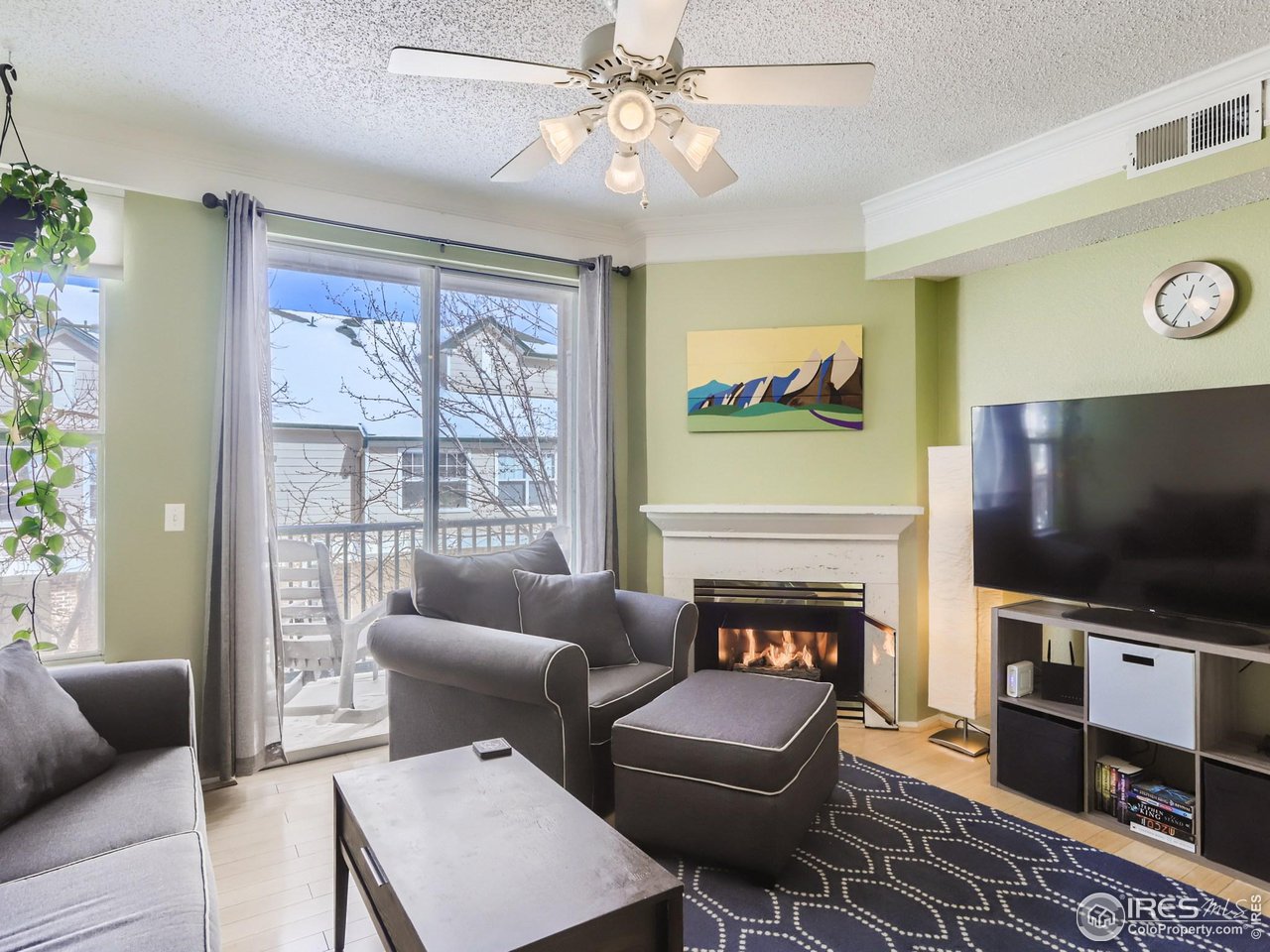 1855 Spaulding Circle Superior, CO 80027 - Photo 2 of 17 a living room with furniture a flat screen tv and a fireplace
