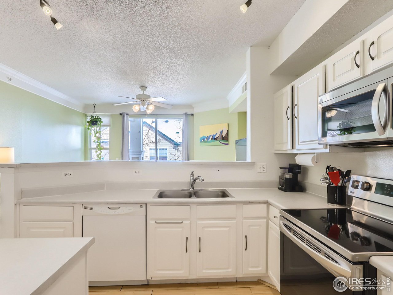 1855 Spaulding Circle Superior, CO 80027 - Photo 4 of 17 a kitchen with granite countertop white cabinets and white appliances