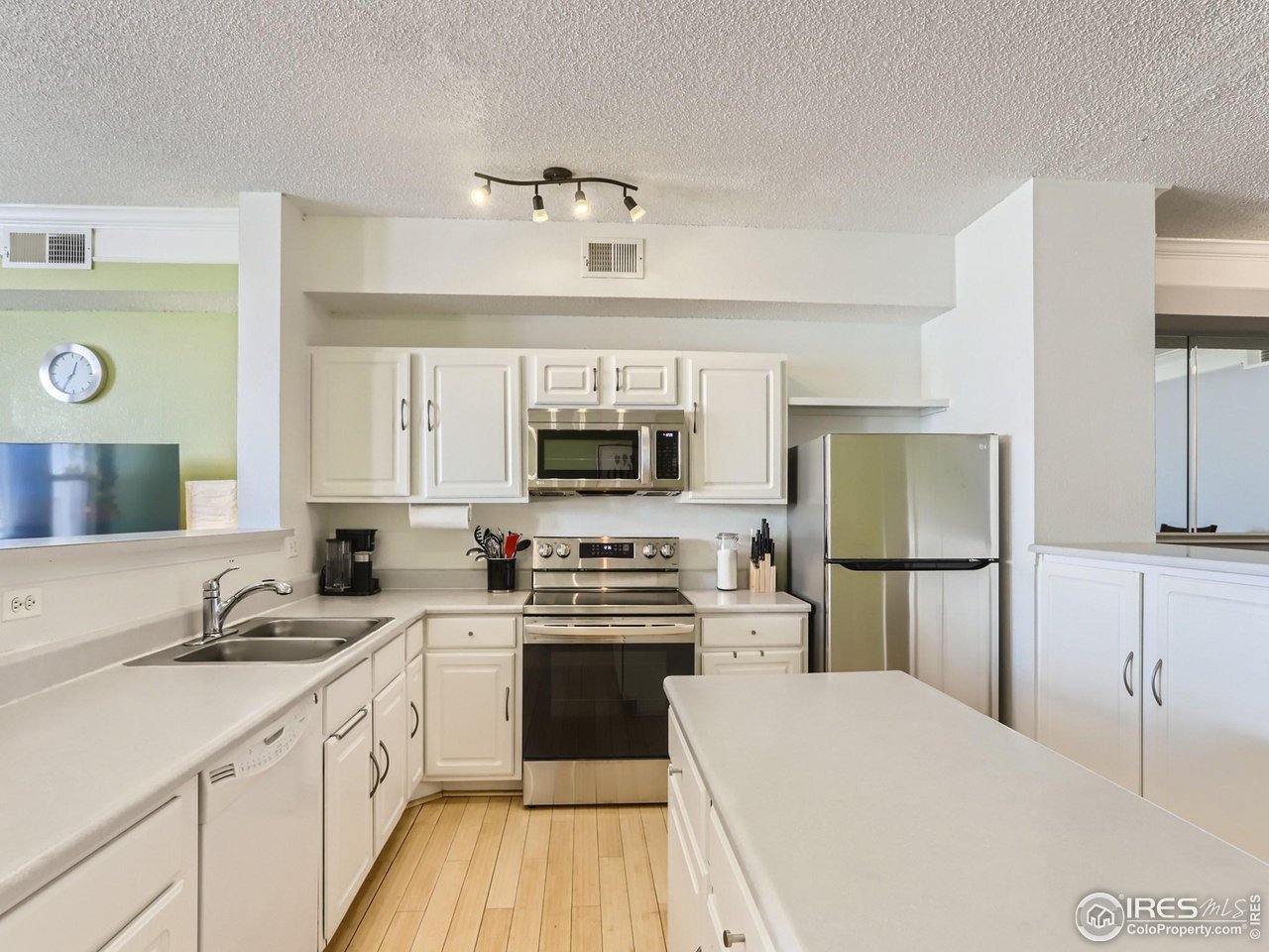 1855 Spaulding Circle Superior, CO 80027 - Photo 5 of 17 a kitchen with a sink a counter top space stainless steel appliances and cabinets