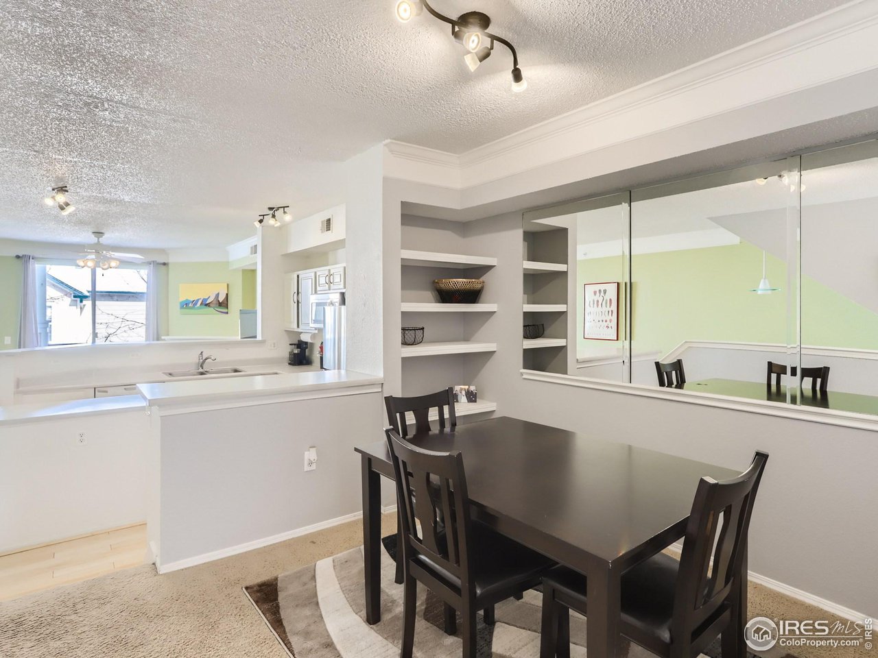 1855 Spaulding Circle Superior, CO 80027 - Photo 6 of 17 a kitchen with a dining table chairs and refrigerator