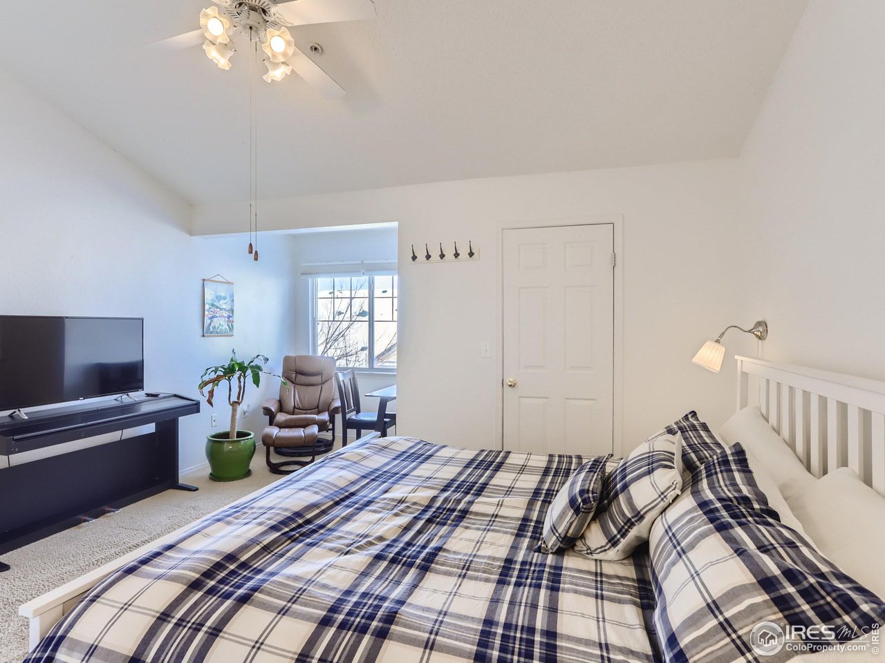 1855 Spaulding Circle Superior, CO 80027 - Photo 9 of 17 a bedroom with a bed and a chandelier