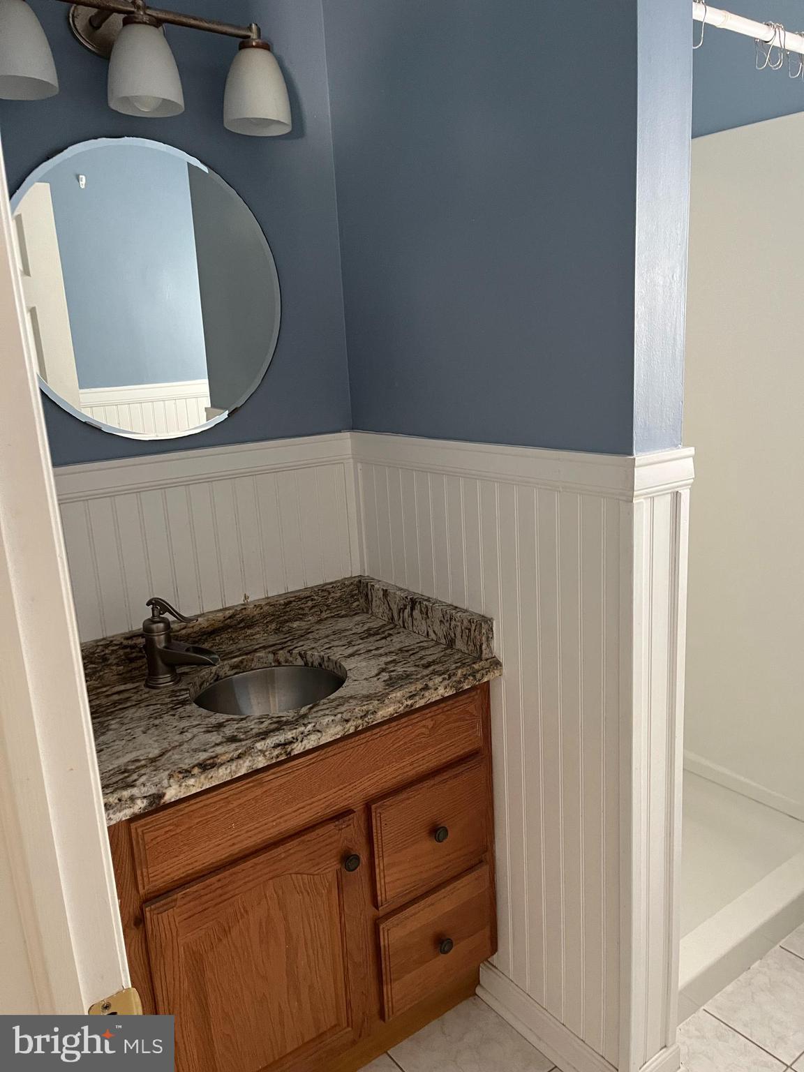114 South Bishop Avenue Springfield, PA 19064 - Photo 12 of 20 a bathroom with a granite countertop sink and a mirror