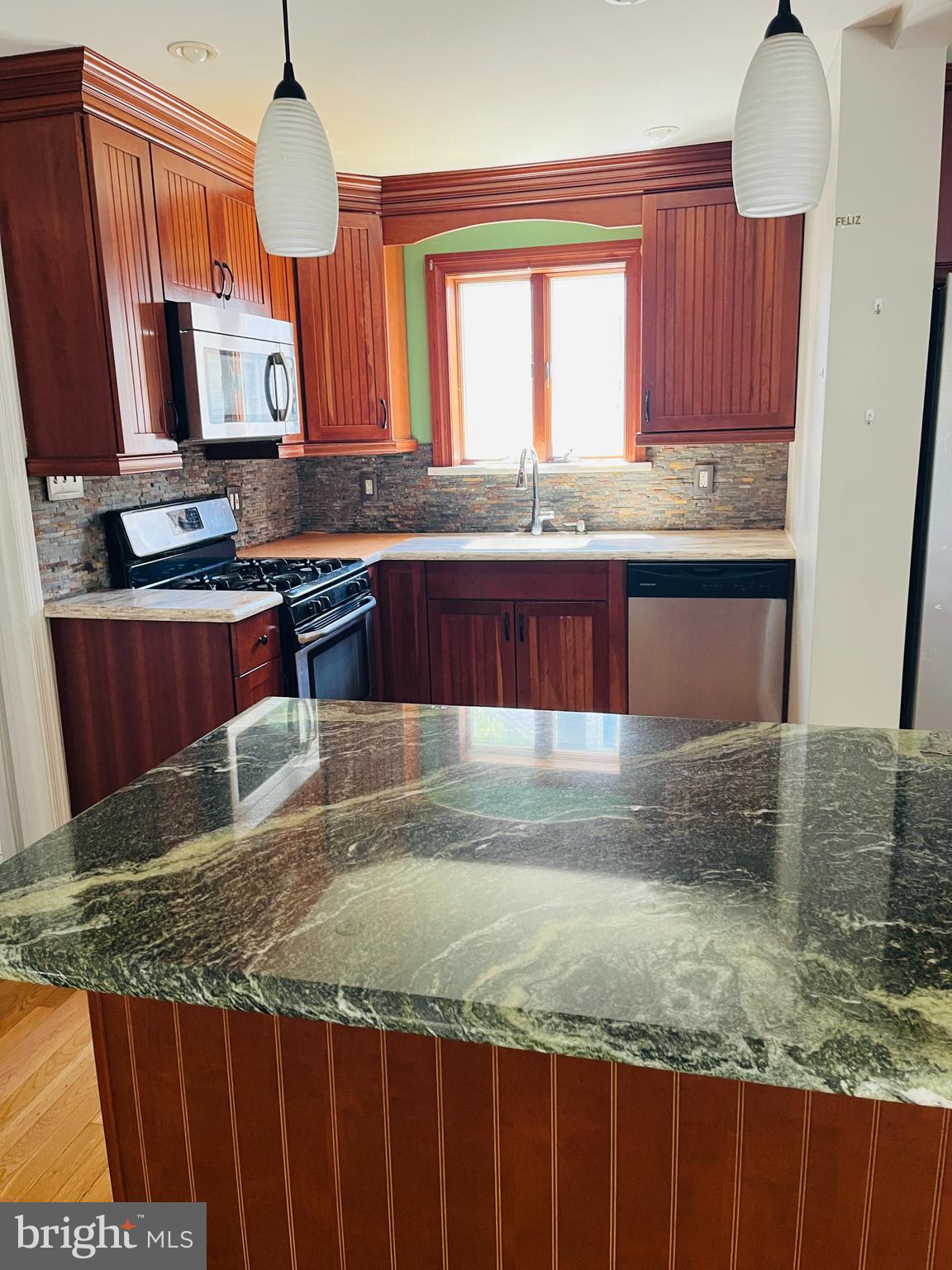 114 South Bishop Avenue Springfield, PA 19064 - Photo 2 of 20 a kitchen with kitchen island granite countertop wooden cabinets a oven and a granite counter top