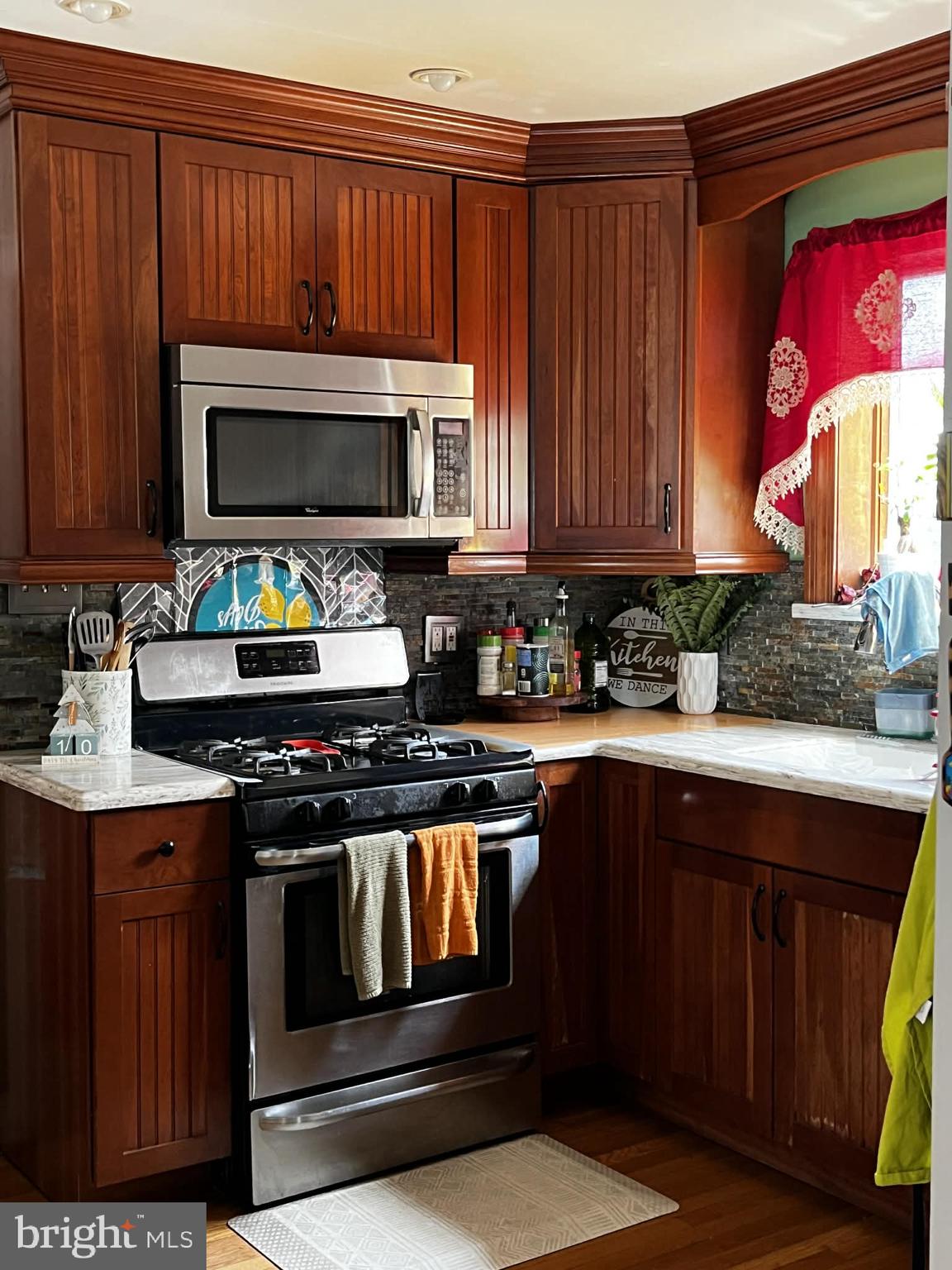 114 South Bishop Avenue Springfield, PA 19064 - Photo 4 of 9 a kitchen with granite countertop wood cabinets and stainless steel appliances