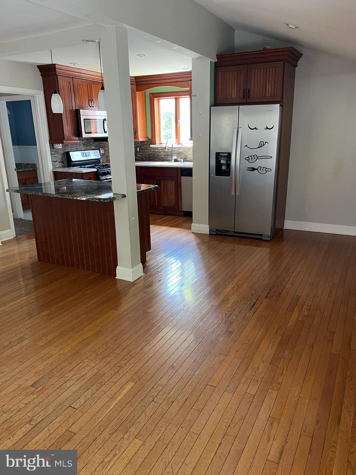 114 South Bishop Avenue Springfield, PA 19064 - Photo 6 of 20 a kitchen with stainless steel appliances wooden floors and wooden cabinets