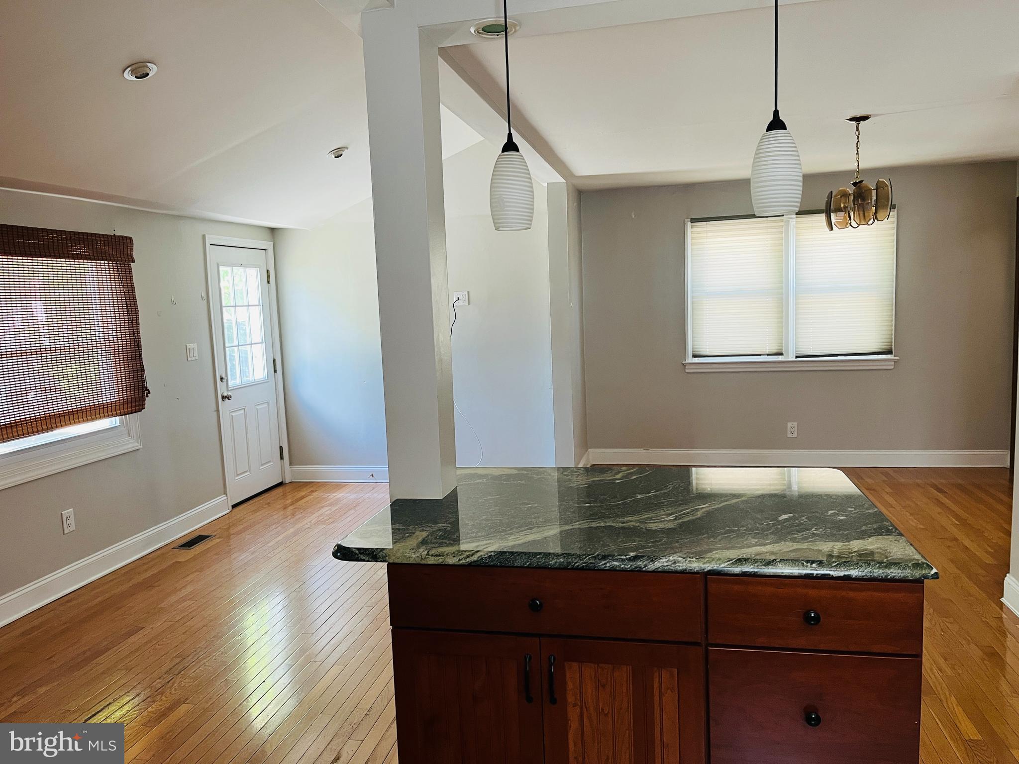 114 South Bishop Avenue Springfield, PA 19064 - Photo 7 of 20 a kitchen with kitchen island granite countertop wooden floor and a refrigerator