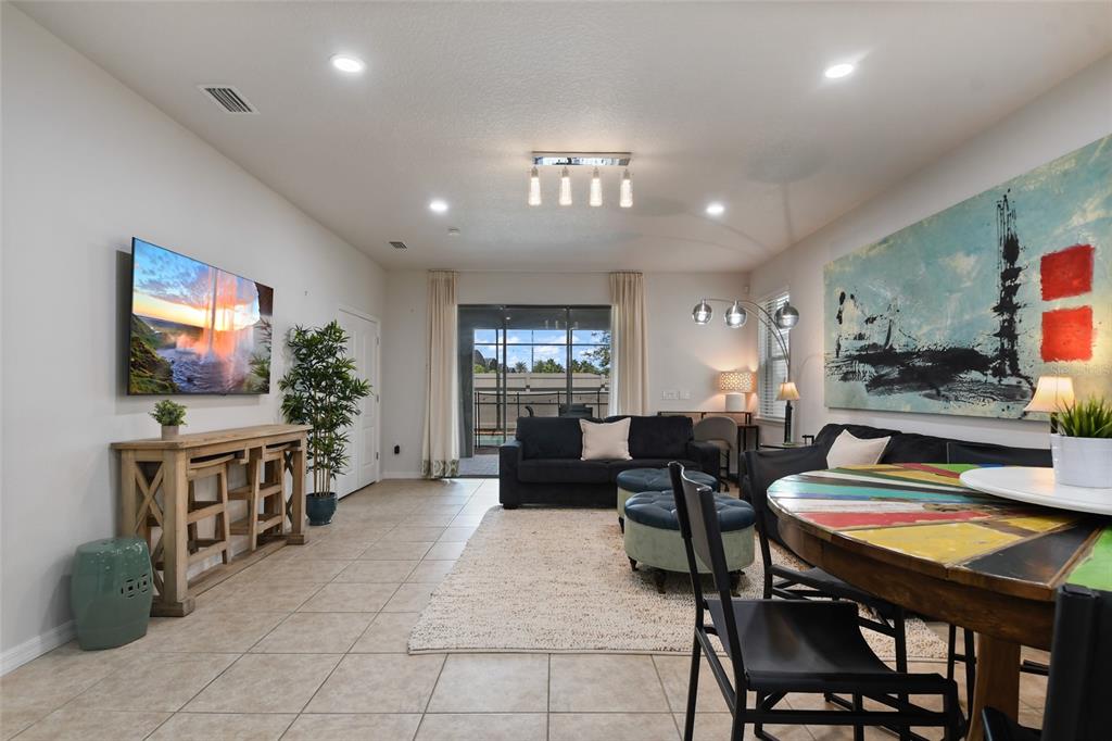 8869 Rhodes Street Kissimmee, FL 34747 - Photo 12 of 66 a living room with furniture and a flat screen tv