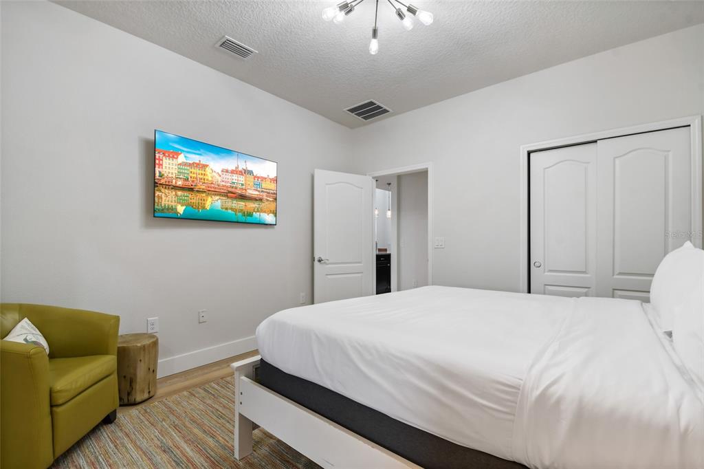 8869 Rhodes Street Kissimmee, FL 34747 - Photo 16 of 66 a bedroom with a bed and a couch