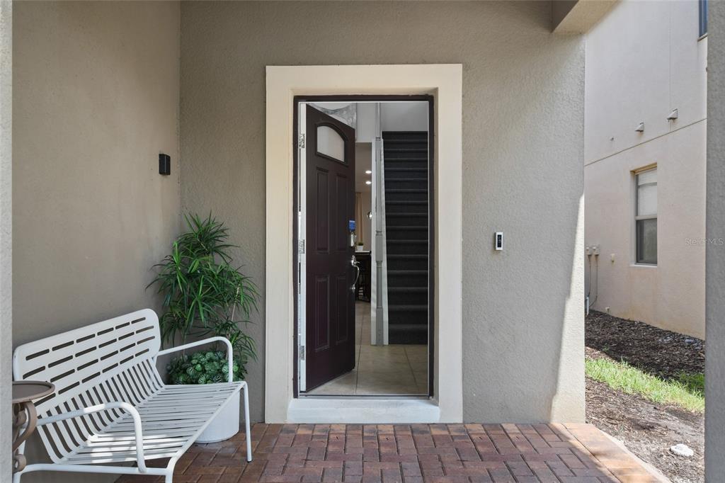 8869 Rhodes Street Kissimmee, FL 34747 - Photo 3 of 66 a view of a porch with a bench