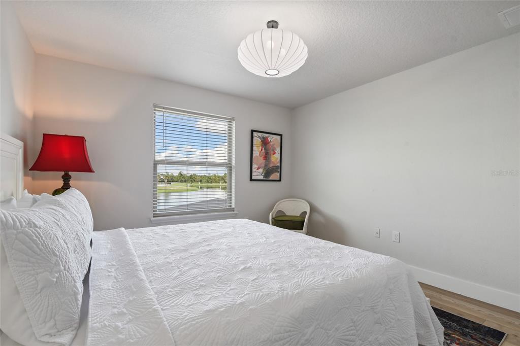 8869 Rhodes Street Kissimmee, FL 34747 - Photo 38 of 66 a bedroom with a bed and a chandelier