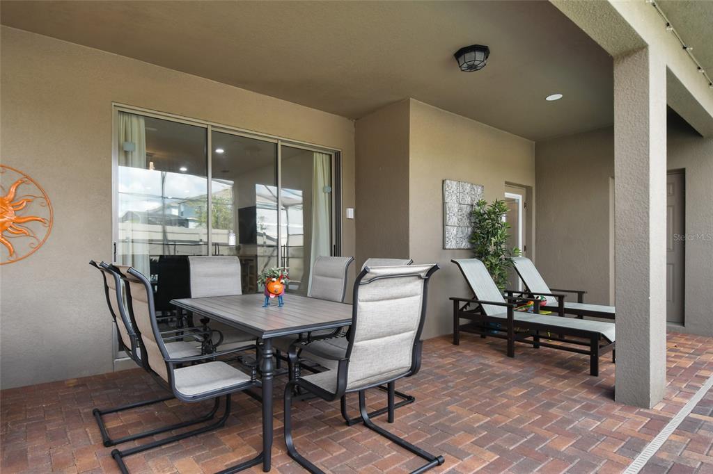 8869 Rhodes Street Kissimmee, FL 34747 - Photo 39 of 66 a dining room with furniture and wooden floor