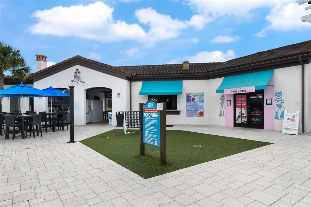 8869 Rhodes Street Kissimmee, FL 34747 - Photo 51 of 66 a front view of a house with yard patio and fire pit