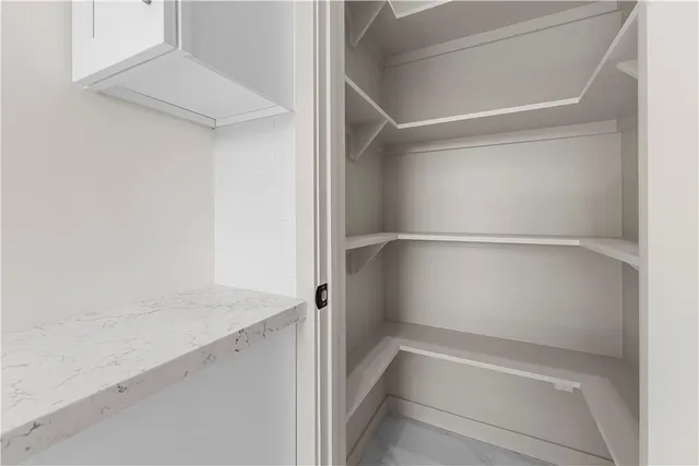 a bedroom with a bed and a potted plant