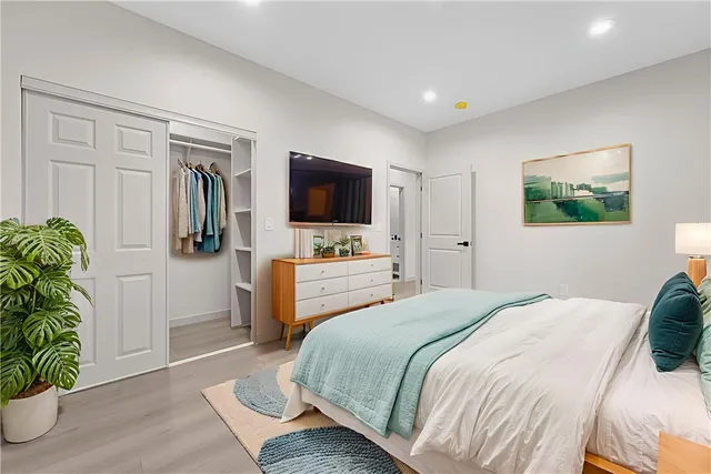 a spacious bedroom with a bed and a window