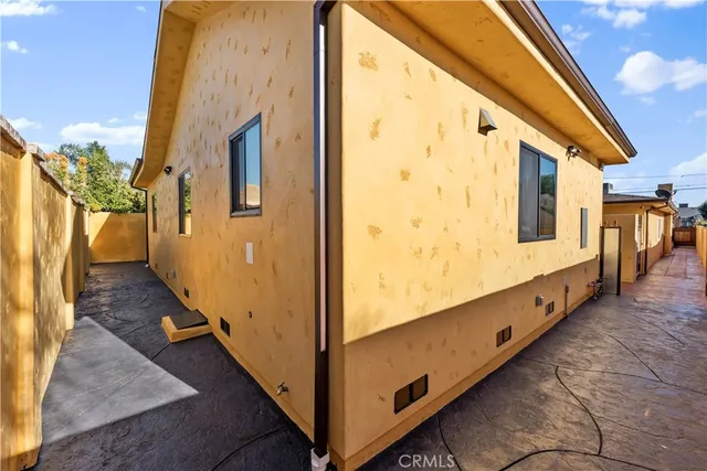 an aerial view of residential houses with outdoor space and trees