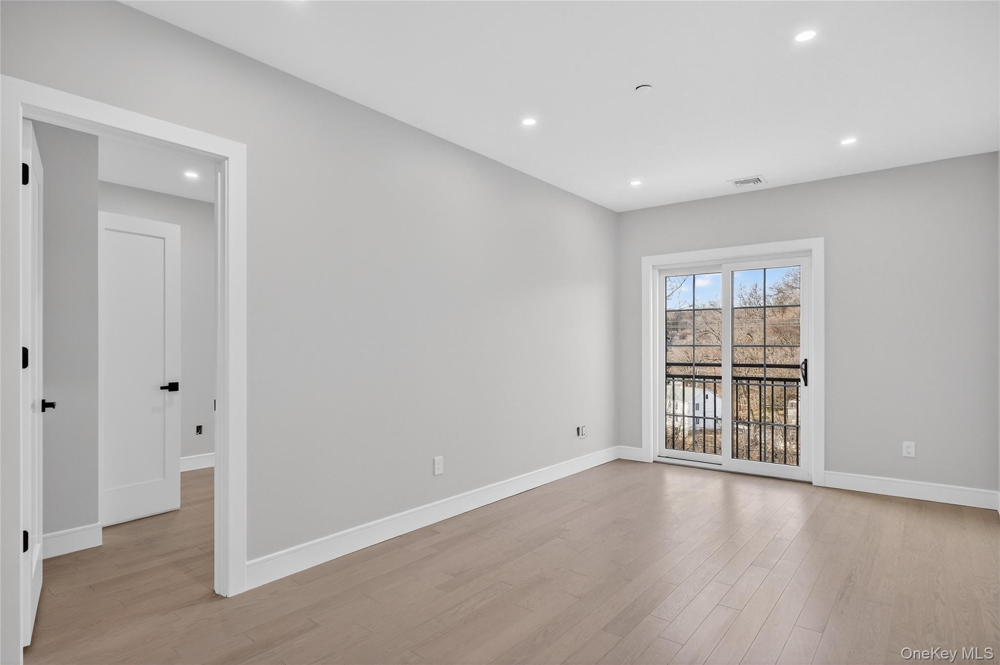 10 Market Street, Unit I Wappingers Falls, NY 12590 - Photo 12 of 26 a view of an empty room with wooden floor and a window