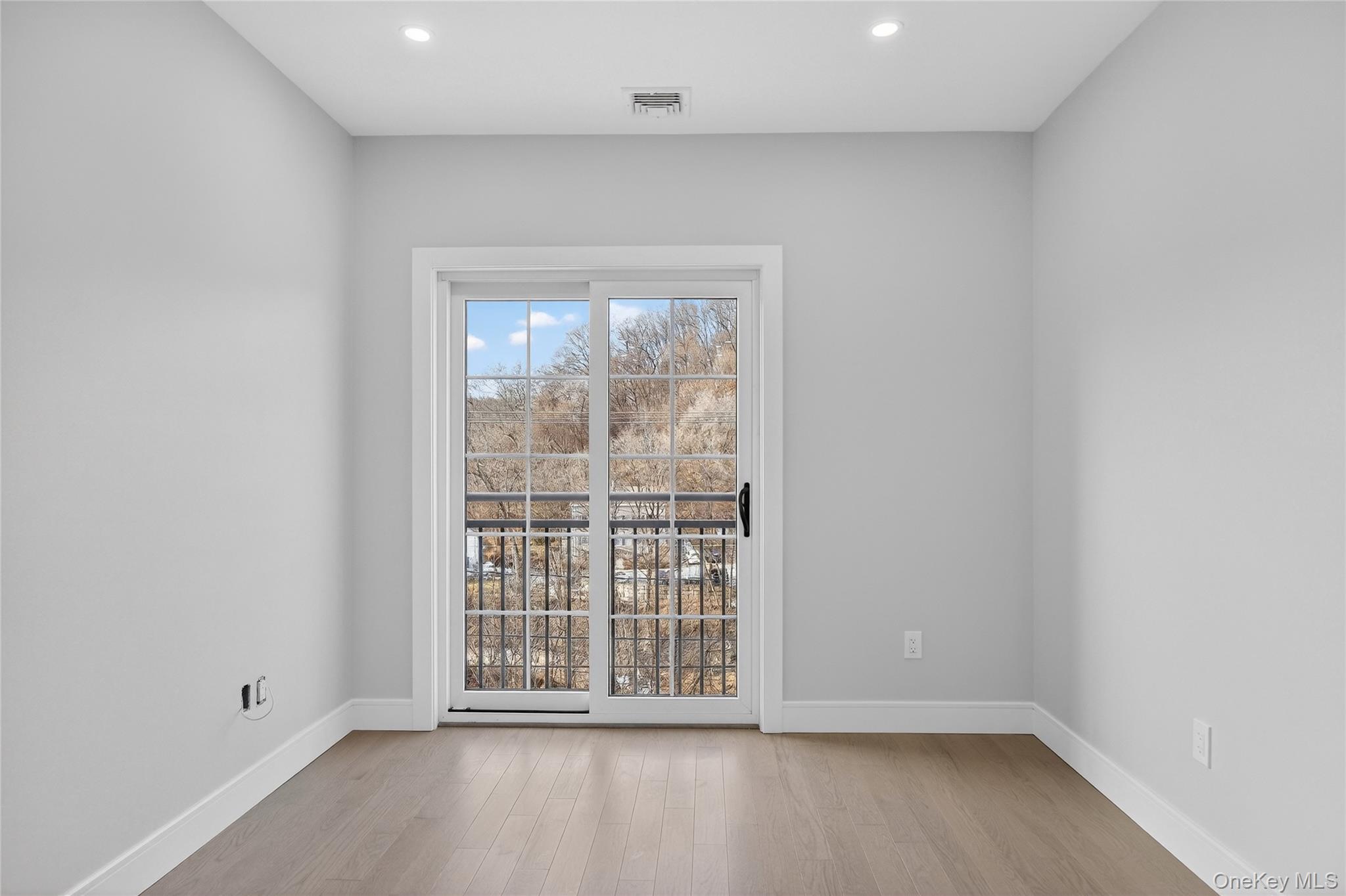 10 Market Street, Unit I Wappingers Falls, NY 12590 - Photo 13 of 26 an empty room with wooden floor and windows