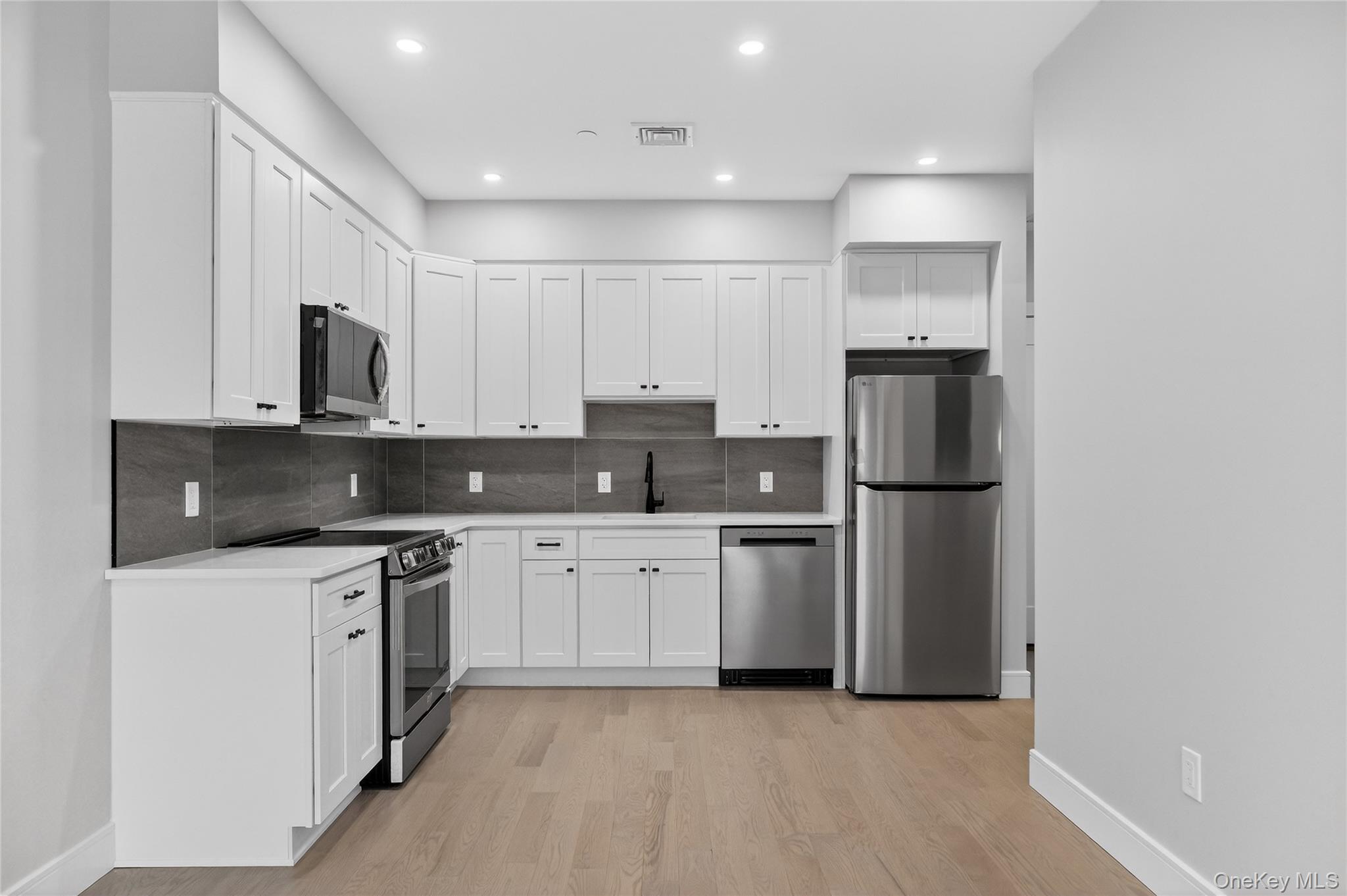 10 Market Street, Unit I Wappingers Falls, NY 12590 - Photo 14 of 26 a kitchen with stainless steel appliances granite countertop a refrigerator sink and stove
