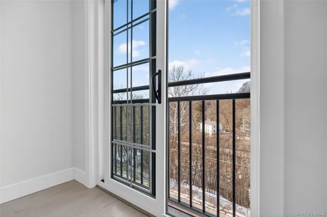 a view of staircase with railing and a window
