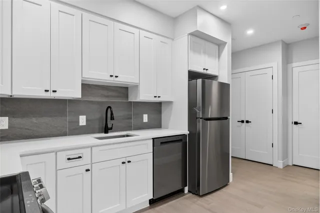 a kitchen with cabinets and stainless steel appliances