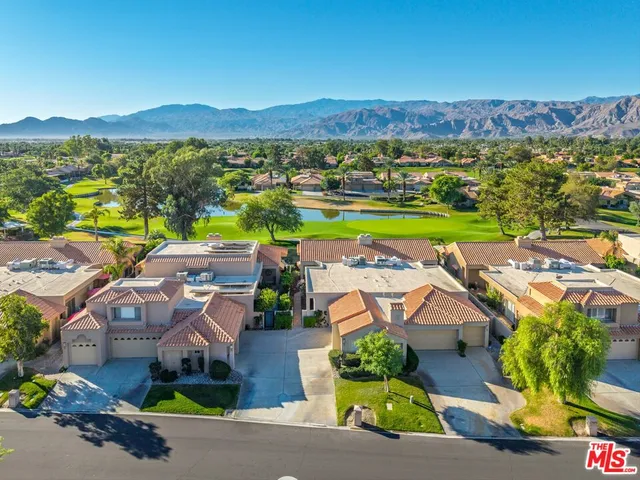 an aerial view of residential houses with outdoor space and river