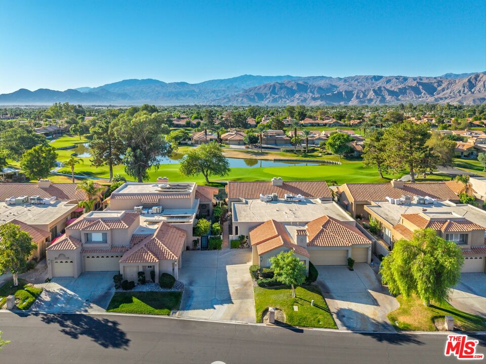 an aerial view of residential houses with outdoor space and river