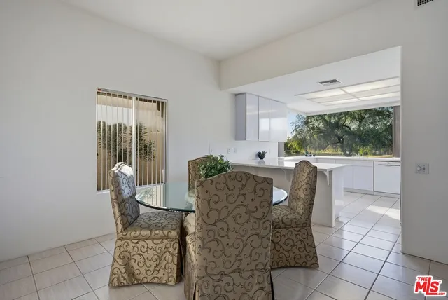 a kitchen with a sink a refrigerator and window