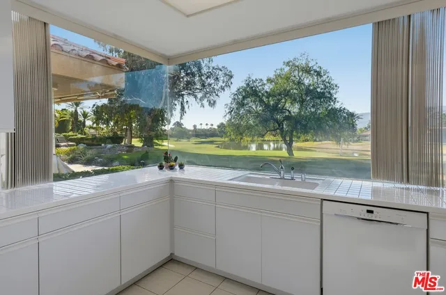 a kitchen with stainless steel appliances cabinets a sink and a stove