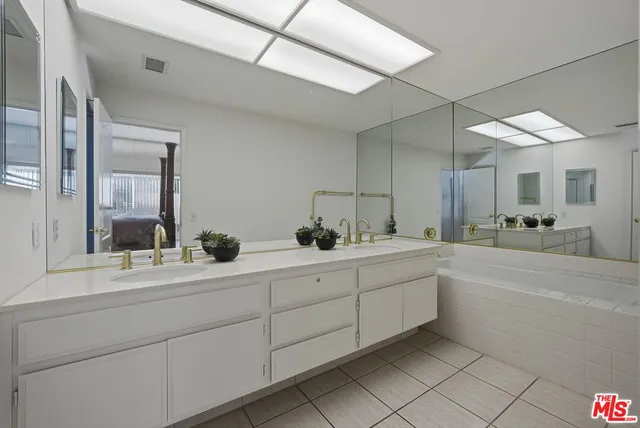 a bedroom with a bed and a mirror