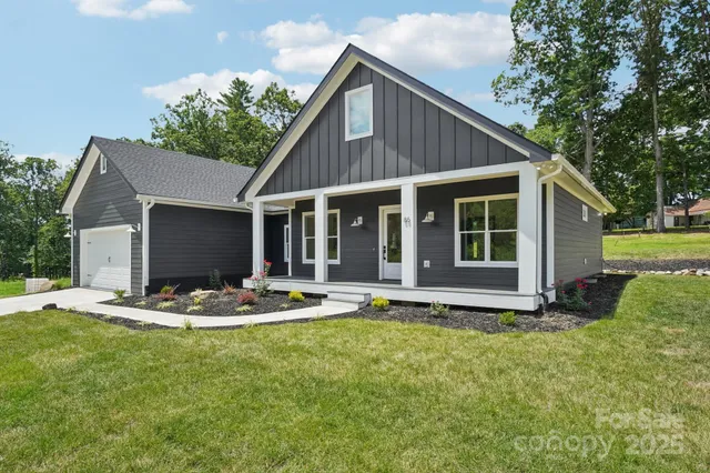 a front view of a house with a yard and porch