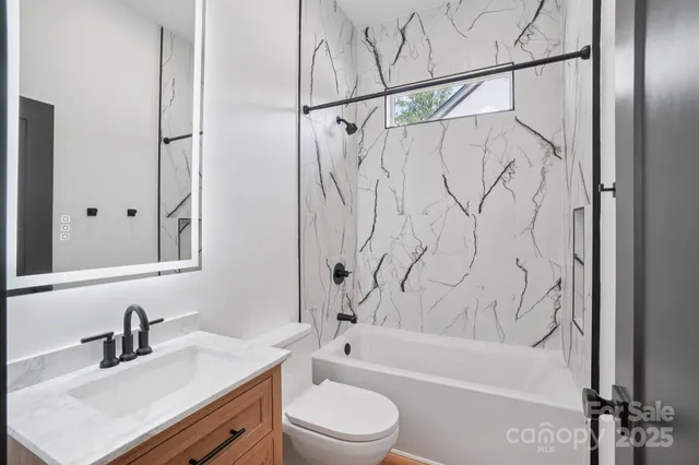 a bathroom with a sink a toilet and a bathtub