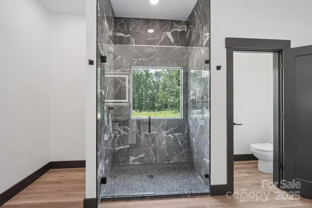 a bathroom with a glass shower door
