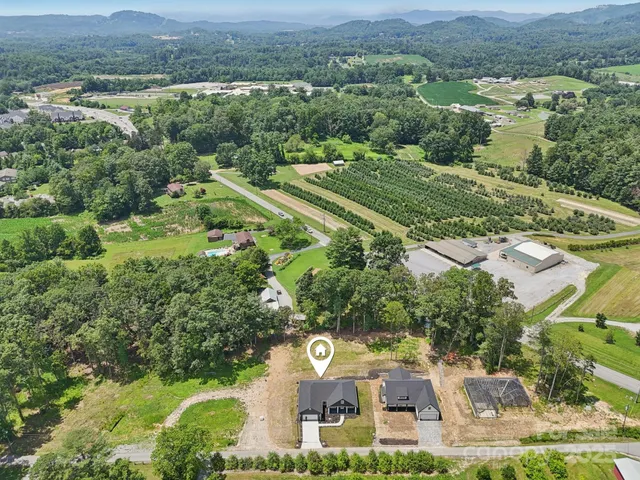 an aerial view of a residential houses with outdoor space and street view