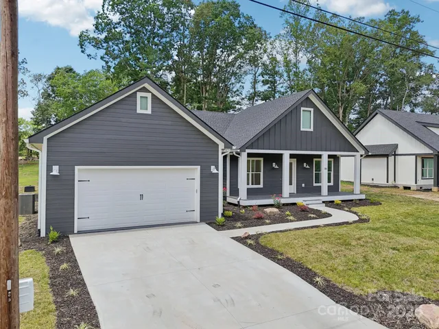 a view of a house with swimming pool next to a yard