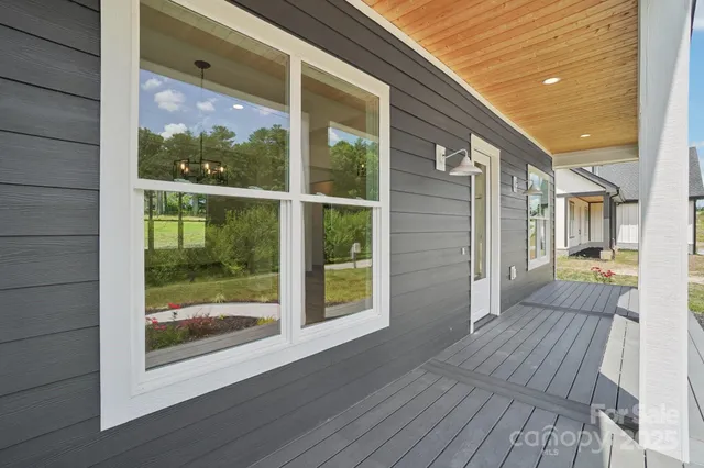 a view of outdoor space with wooden floor and windows