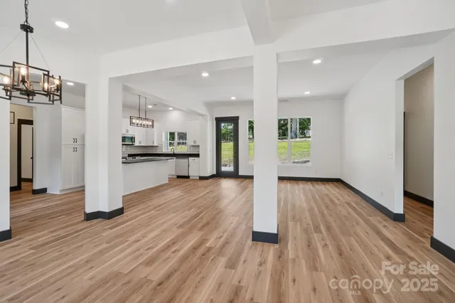 a view of a kitchen with wooden floor and a refrigerator