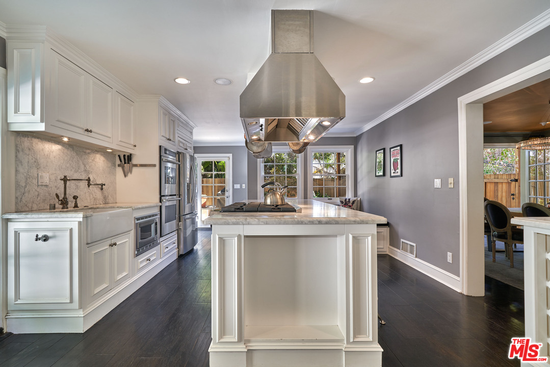1488 North Kings Road Los Angeles, CA 90069 - Photo 16 of 53 a kitchen with stainless steel appliances granite countertop a sink a stove and a refrigerator