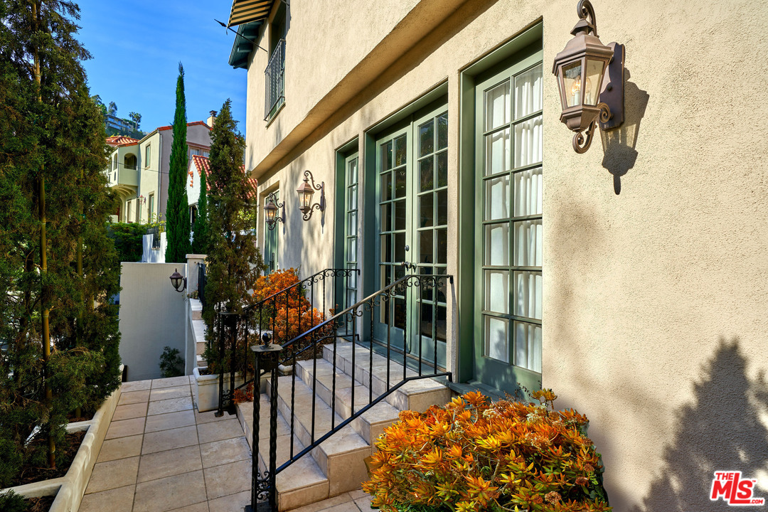 1488 North Kings Road Los Angeles, CA 90069 - Photo 3 of 53 a view of a house with a wooden door and glass door