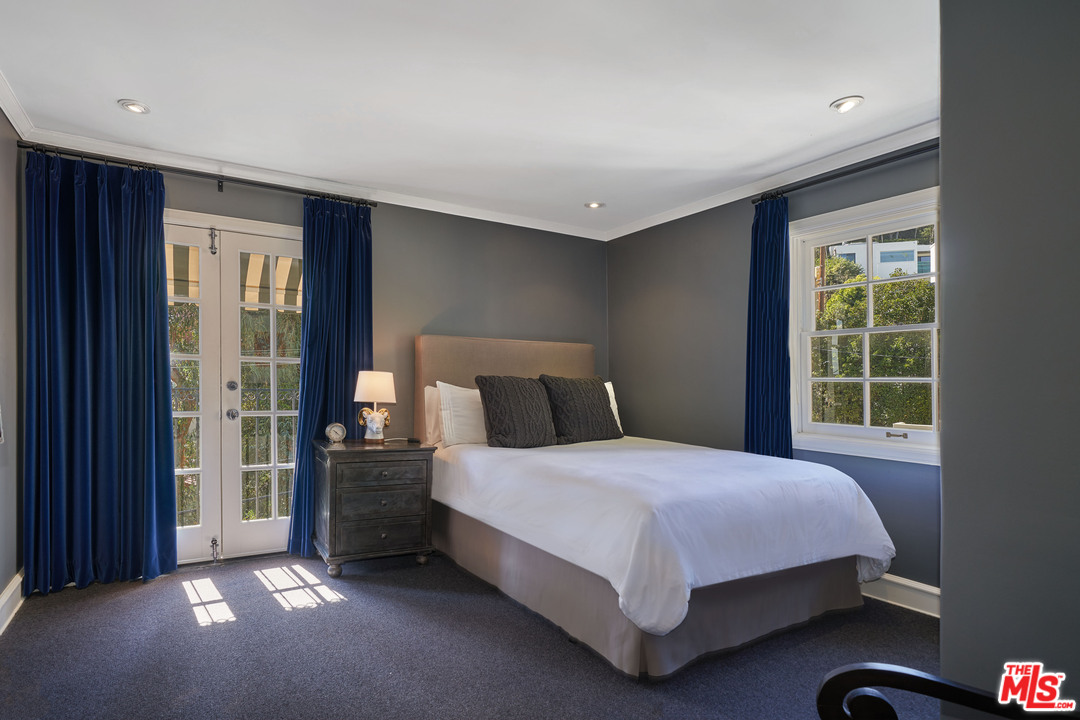 1488 North Kings Road Los Angeles, CA 90069 - Photo 21 of 53 a bed sitting in a spacious bedroom next to a window