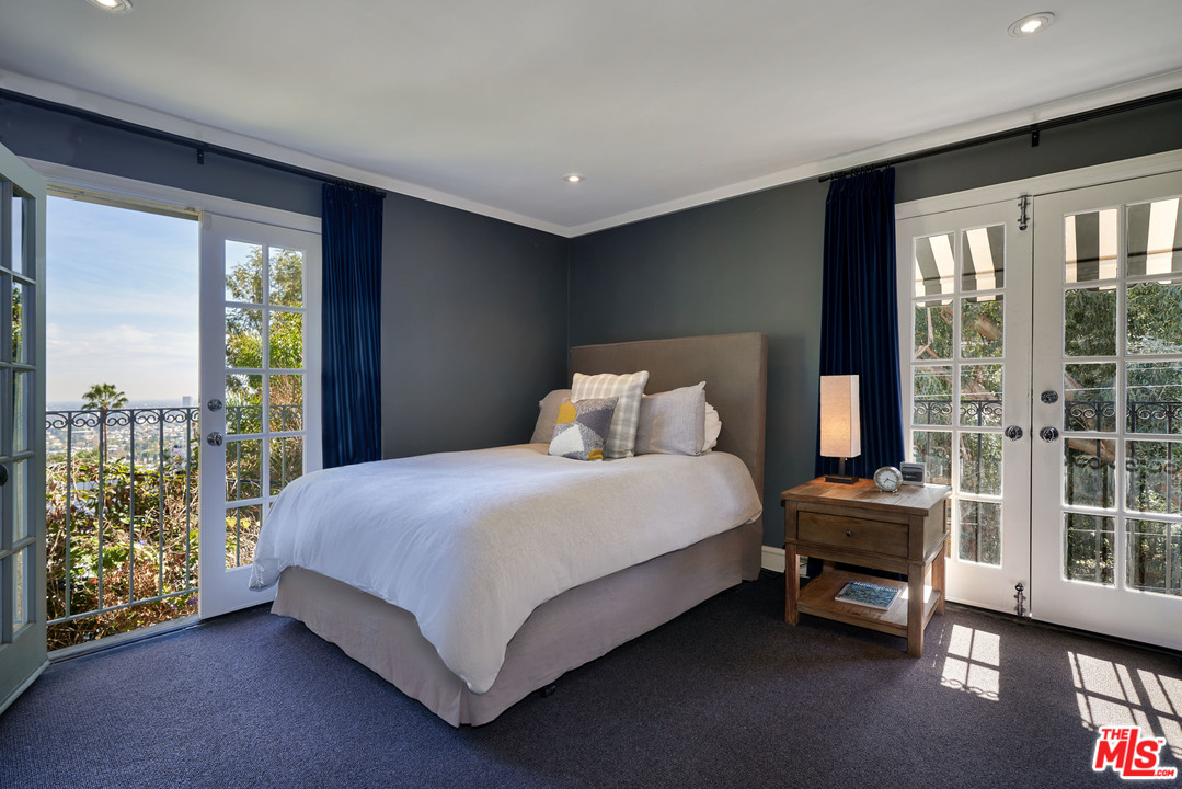 1488 North Kings Road Los Angeles, CA 90069 - Photo 23 of 53 a bedroom with a bed and a window