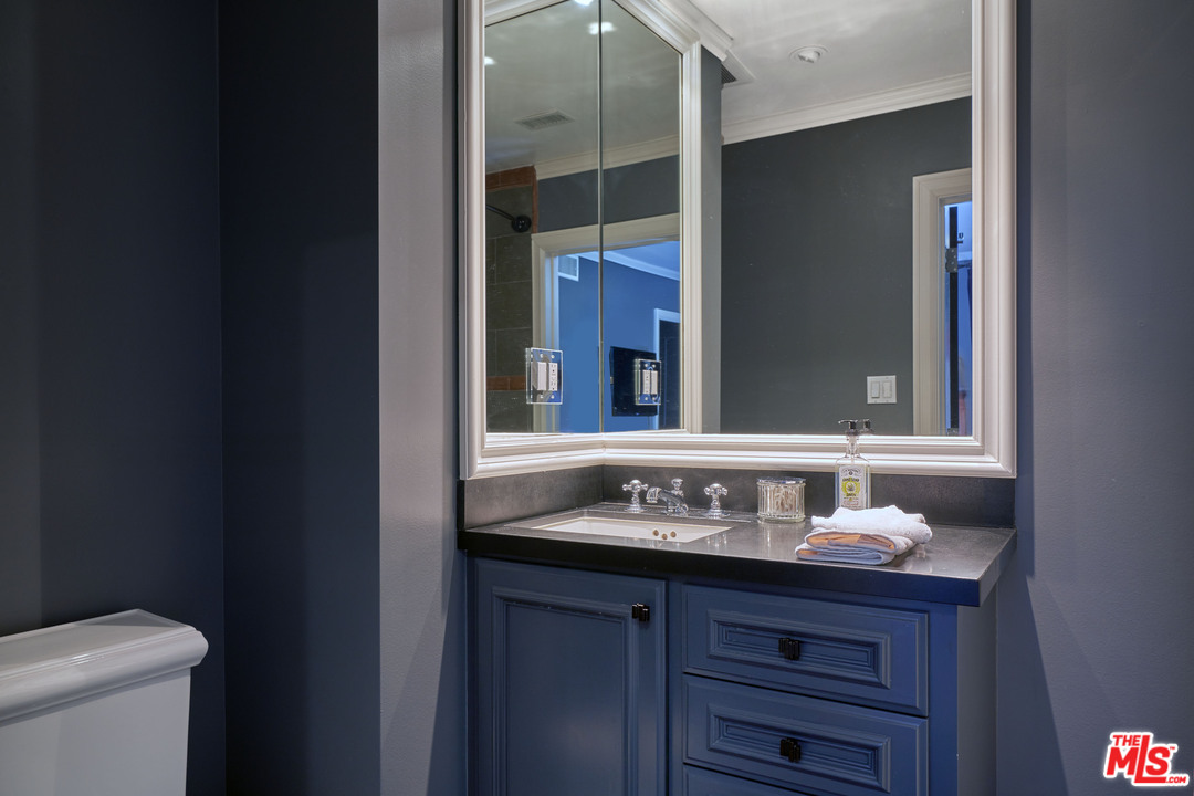 1488 North Kings Road Los Angeles, CA 90069 - Photo 24 of 53 a bathroom with a sink and a mirror