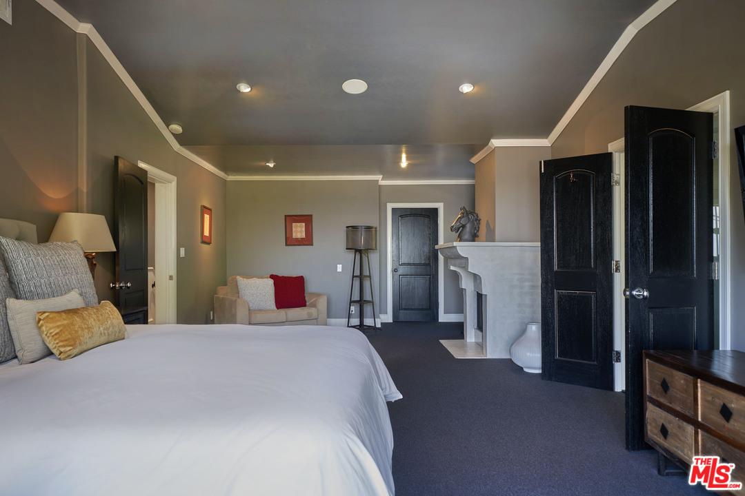 1488 North Kings Road Los Angeles, CA 90069 - Photo 28 of 53 a bed room with a bed and a television