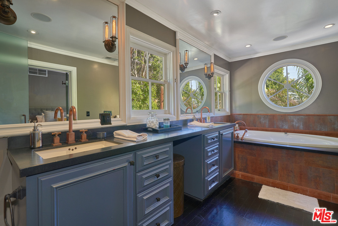 1488 North Kings Road Los Angeles, CA 90069 - Photo 31 of 53 a bathroom with a sink and a large mirror