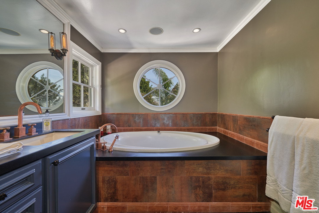 1488 North Kings Road Los Angeles, CA 90069 - Photo 32 of 53 a bathroom with a sink and a mirror