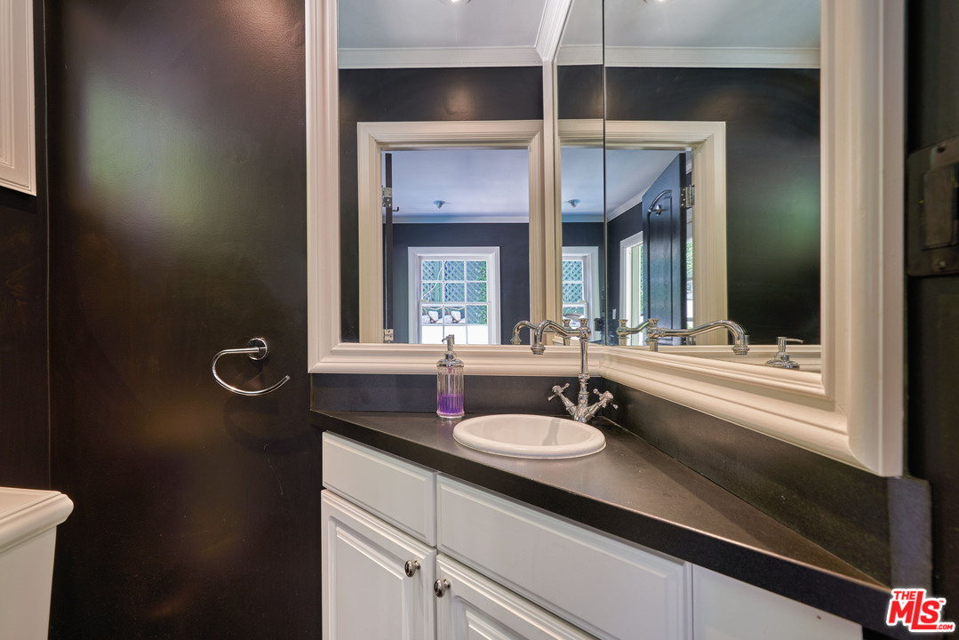 1488 North Kings Road Los Angeles, CA 90069 - Photo 40 of 53 a bathroom with a sink double vanity and a mirror