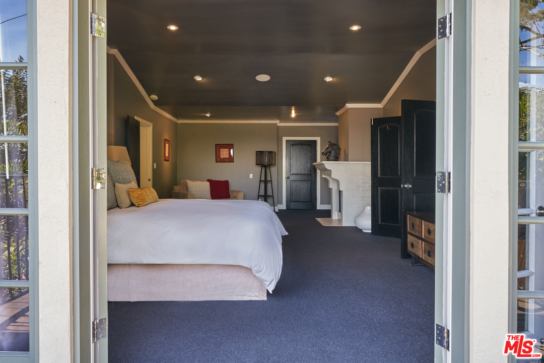 1488 North Kings Road Los Angeles, CA 90069 - Photo 48 of 53 a bed room with a bed and a large mirror