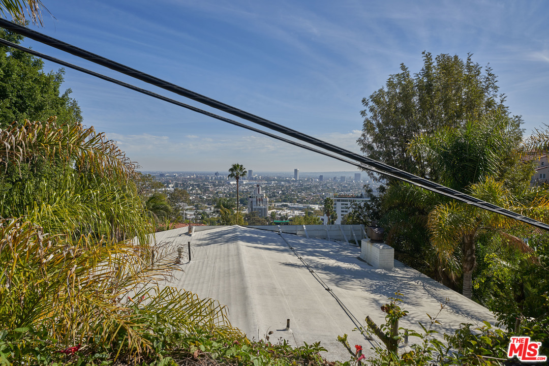 1488 North Kings Road Los Angeles, CA 90069 - Photo 52 of 53 a view of a balcony with floor to ceiling windows and wooden fence